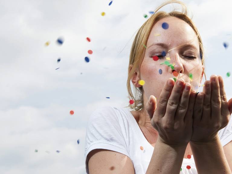 Woman blowing confetti